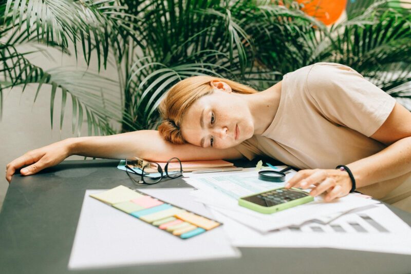 A Woman using a Calculator using Smartphone