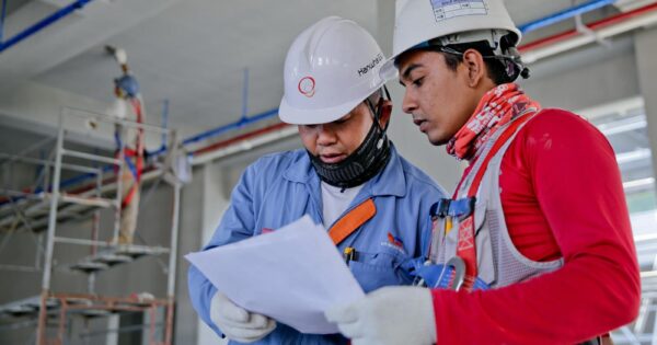 Two Man Holding White Paper