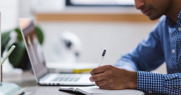 man, writing, laptop