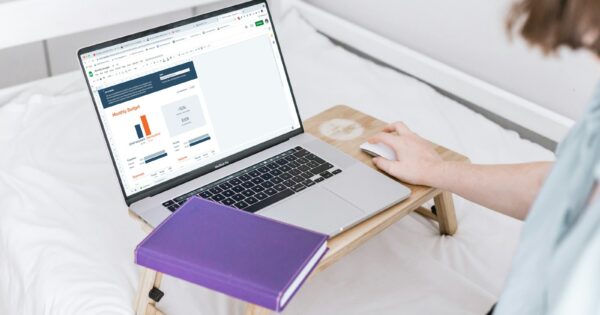 a person using a laptop on a bed