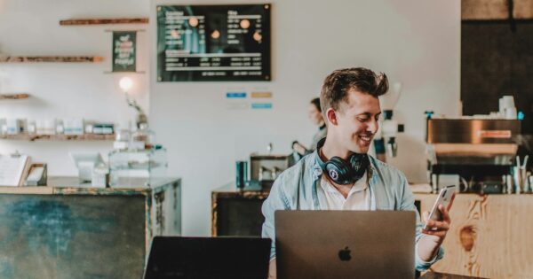 man using smartphone smiling